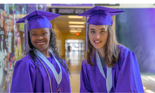  Kasia Hurlburt (right) and Jocelyn Gaines (left) smile in their purple caps and gowns